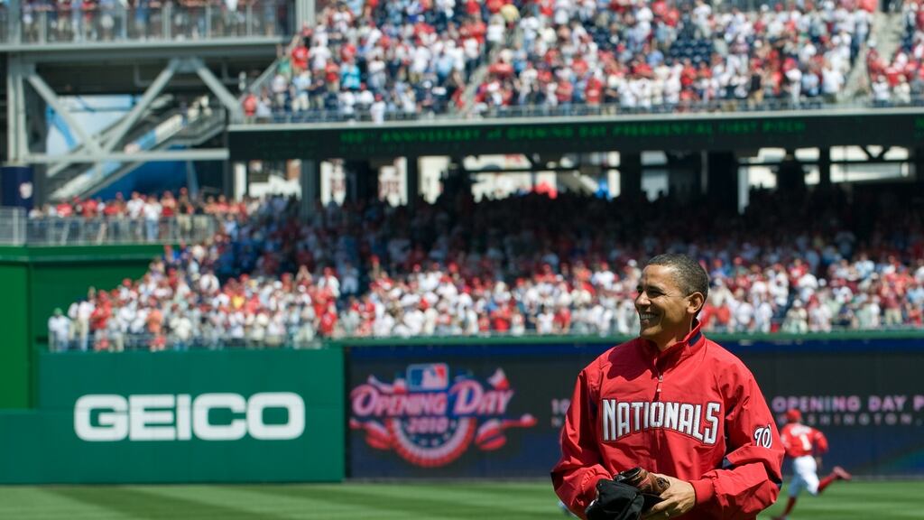 US president Barack Obama smiles after throwing out the first pitch at Nationals Park in 2010, on baseball’s opening day. Photograph: Saul Loeb/AFP/Getty Images