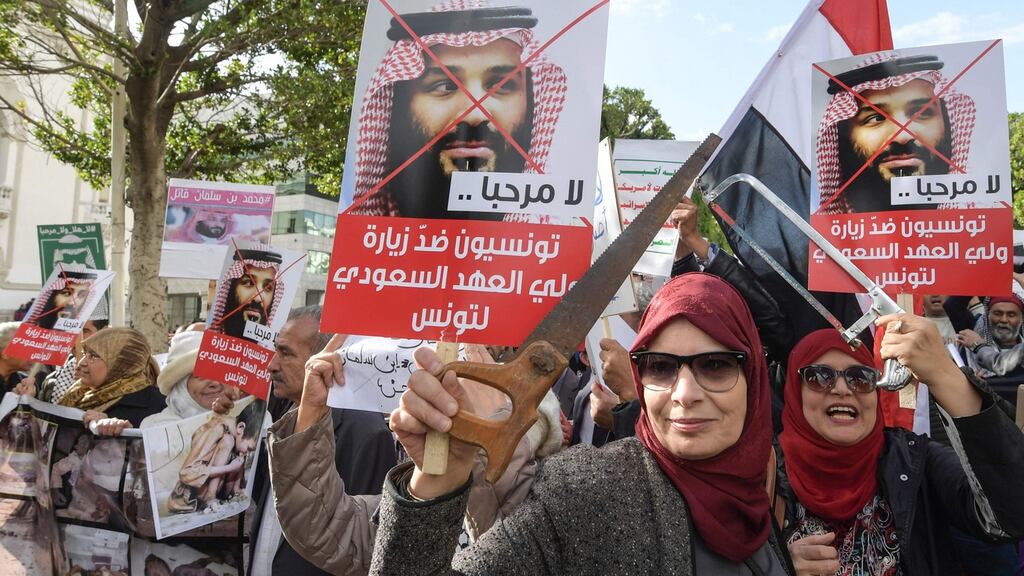 Tunisian women hold up saws and signs showing pictures of Saudi Crown Prince Mohammed bin Salman with a caption below reading in Arabic “no welcome, Tunisians against the visit of the Saudi Crown Prince to Tunisia”, during an anti-Saudi Crown Prince protest in the capital, Tunis on November 27th Photograph: Fethi Belaid/ AFP/Getty