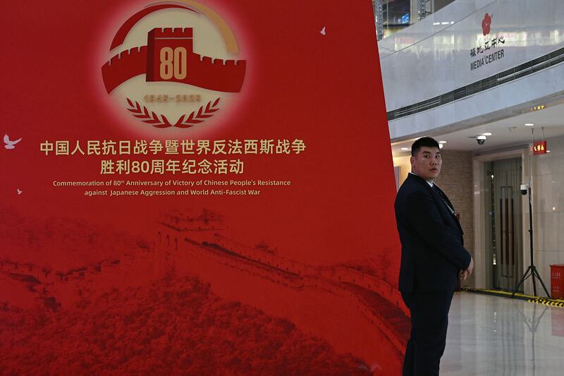 A security official in Beijing keeps watch beside signage commemorating the 80th anniversary of the victory over Japan and the end of the second World War. Photograph: Jade Gao/AFP via Getty Images