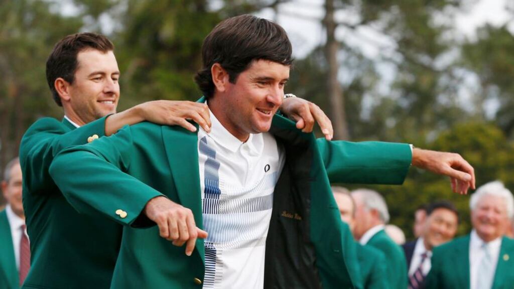 Masters winner Bubba Watson is presented with his green jacket by 2013 winner Adam Scott after winning the US Masters at the Augusta National golf club in Augusta, Georgia. Photo: Jim Young/Reuters