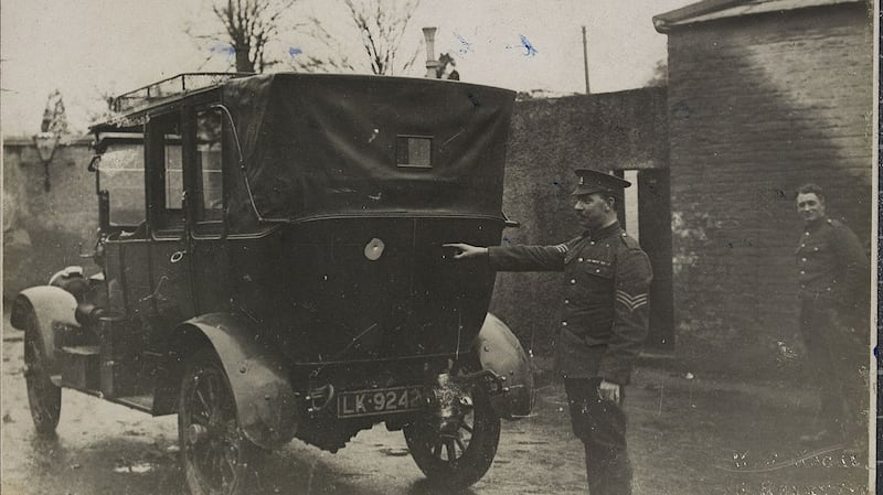 A Dublin Metropolitan Police officer points out the bullet holes in the back of the lord lieutenant John French’s car