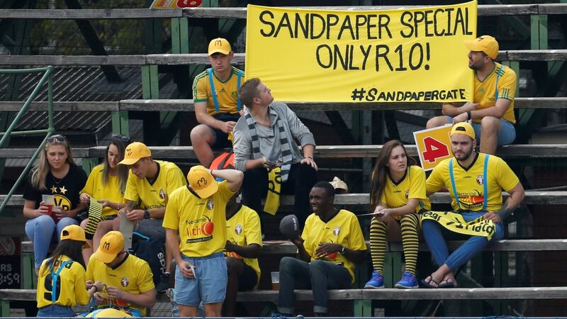 Fans display a banner in the stands at Wanderers Stadium during the first day of the Fourth Test match between South Africa and Australia. Photograph: Siphiwe Sibeko/Reuters