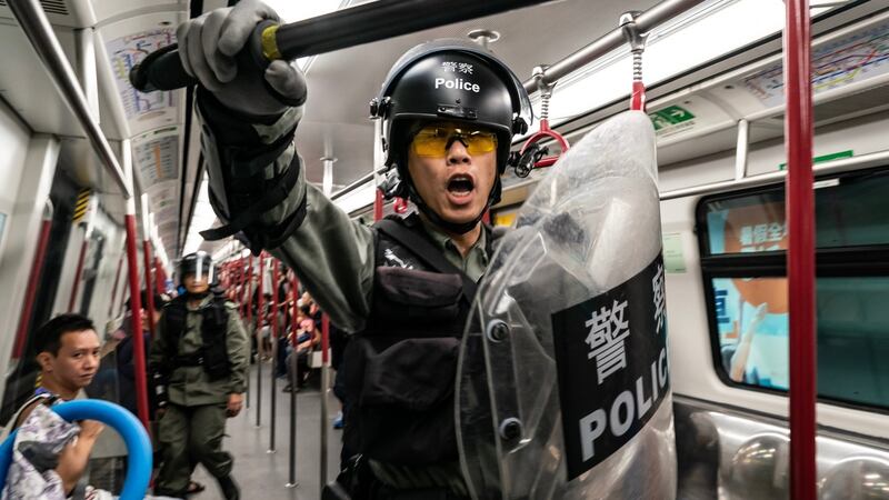 Riot police charge in a train at the Tung Chung MTR station after protesters block the transport routes to the Hong Kong International Airport on Sunday. Photograph: Anthony Kwan/Getty Images