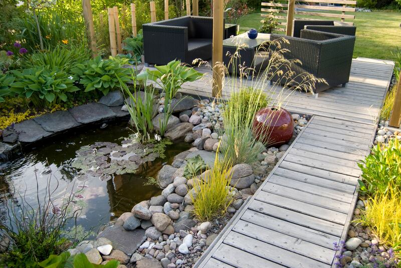 A beautiful small pond and a patio with a sitting area. Photograph: Getty