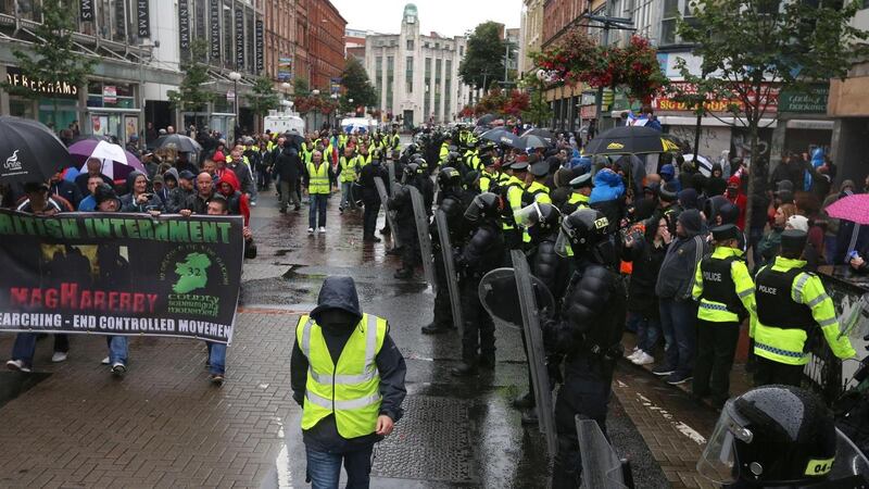 Police separate loyalist  protesters from a republican parade in Belfast city centre this afternoon. Photograph: Niall Carson/PA Wire
