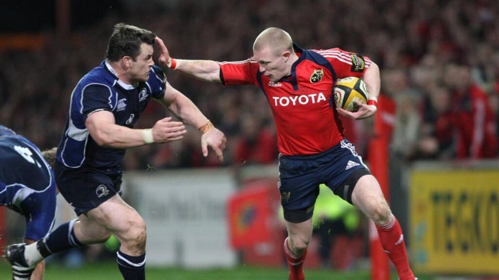 Munster’s Keith Earls hands off Cian Healy of Leinster during a derby game. Photograph: Billy Stickland/Inpho