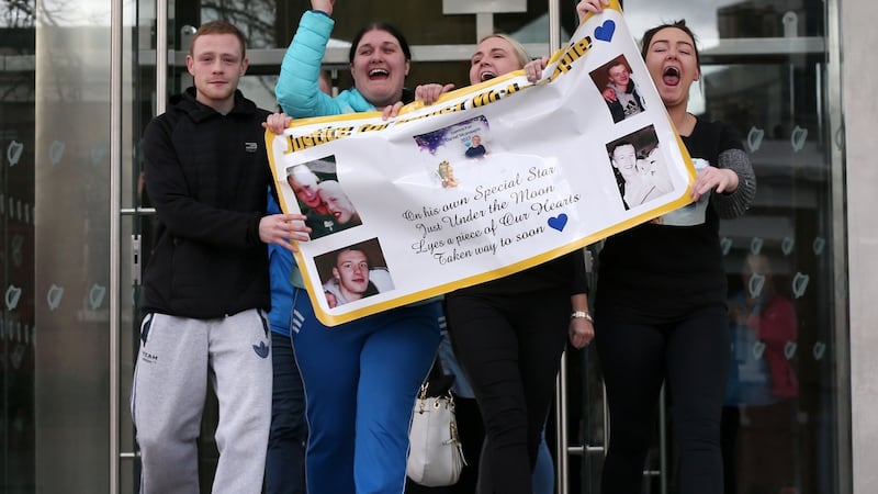Family and friends of the late Daniel McAnaspie celebrate outside the Central Criminal Court in Dublin on Tuesday after Richard Dekker was found guilty of his murder. Photograph: Collins Courts.