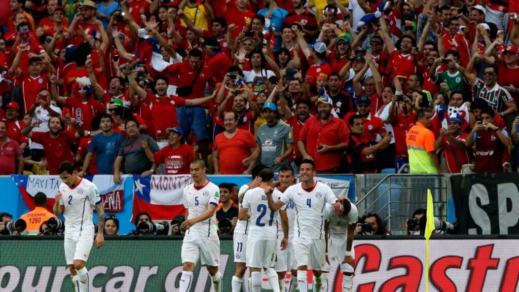 Chilean players celebrate in front of supporters after Charles Aranguiz made it 2-0 against Spain in the World Cup Group B match at Estadio do Maracana in Rio de Janeiro. Photograph: Abedin Taherkenareh/EPA