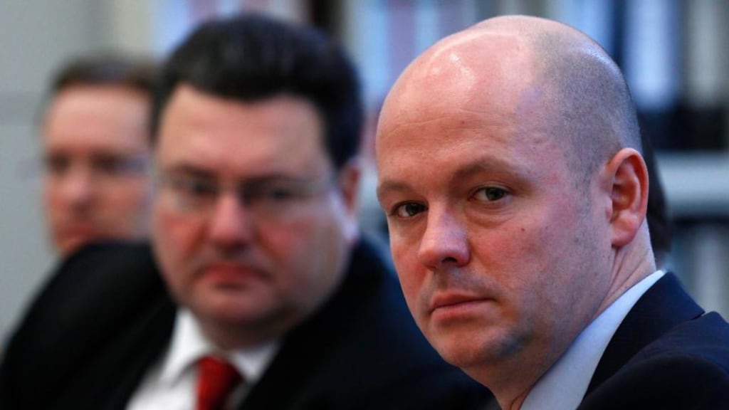 Lead prosecutor Christian Wefers (right) and lawyers await the start of the claim for damages trial against German property lender Hypo Real Estate in a courtroom in Munich. Photograph: Michaela Rehle/Reuters
