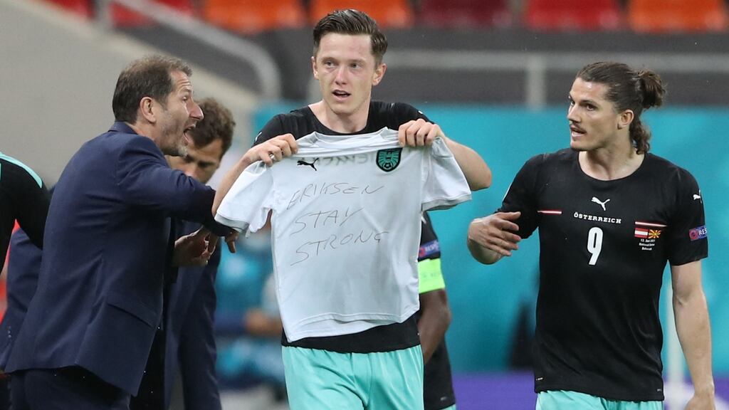 Michael Gregoritsch holds a t-shirt reading “Eriksen, stay strong”, after scoring against North Macedonia. Photograph: Getty Images