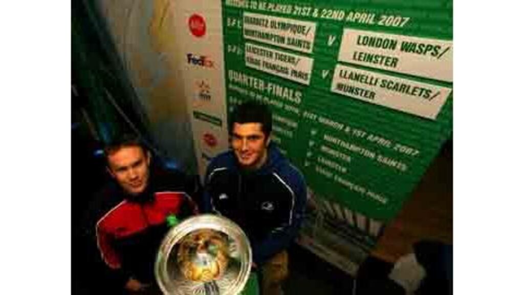 Munster's John Kelly and Rob Kearney from Leinster with the
Heineken European Cup at yesterday's semi-final draw at Twickenham.
Both sides, if they make it through their respective quarter-final
games, face tough away ties in order to advance to the final.
Photograph: Billy Stickland/Inpho