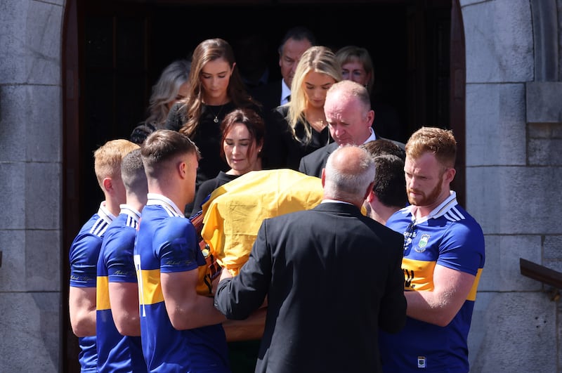 Tipperary players carry the coffin followed by parents Dan and Hazel and sisters Shannon and Kellie following the funeral Mass of Dillon Quirke at St John the Baptist Church, Clonoulty, Co Tipperary.
Photograph: Dara MacDónaill/The Irish Times