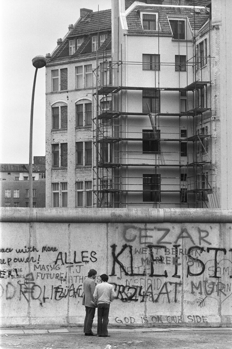 Various graffiti are painted on the Berlin Wall on the West Berlin side. Photograph: Joel Robine/AFP/Getty