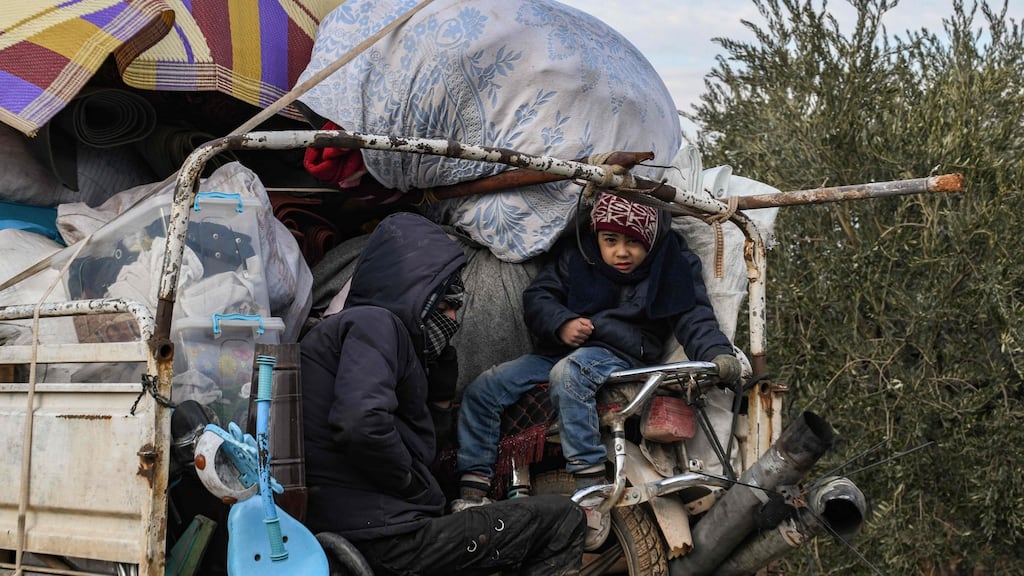 A truck passing through the town of Jindayris in Syria’s Aleppo province. Displaced Syrians are fleeing from advancing government forces in Idlib and Aleppo provinces. Photograph: Rami al Sayed/AFP via Getty Images