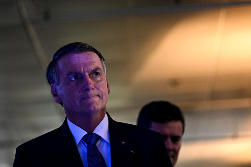 Brazilian President and candidate for the Liberal Party Jair Bolsonaro leaves after holding a press conference after a debate at Globo TV studios in Rio de Janeiro. Photograph: Mauro Pimentel/AFP