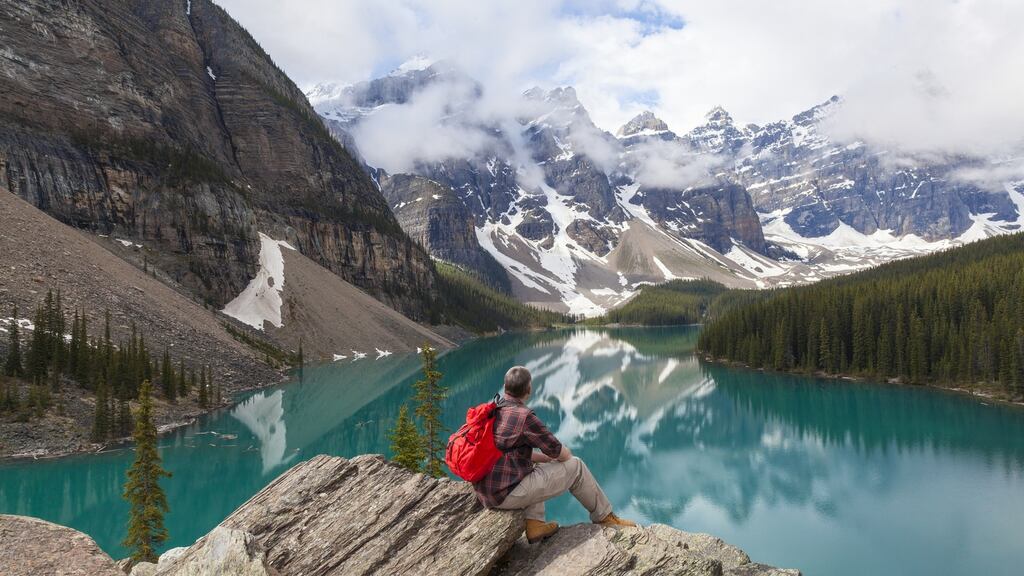 Visit Canada on a working holiday visa and see Moraine Lake and the snow-covered Rocky Mountain peaks in Banff National Park, Alberta. Photograph: Getty Images/iStockphoto