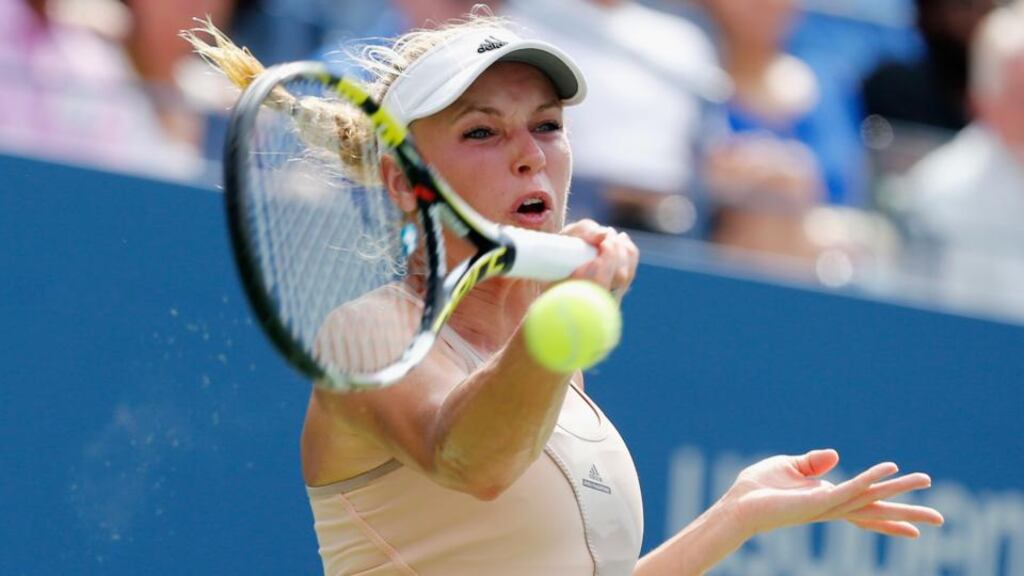 Caroline Wozniacki of Denmark returns a shot against Shuai Peng of China during their women’s singles semi-final match on Day Twelve of the 2014 US Open. Photograph: Mike Stobe/Getty Images for USTA