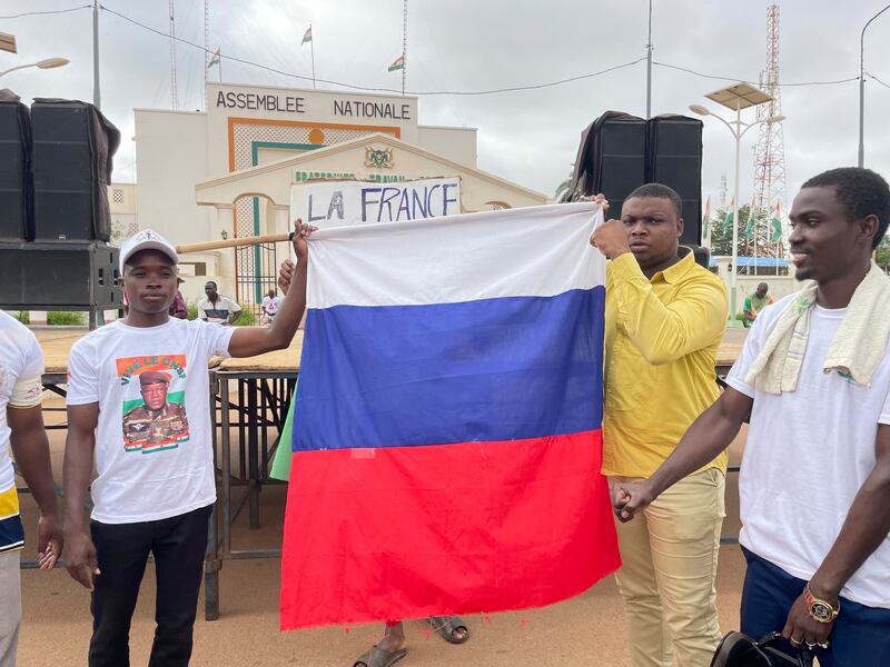 Supporters of Niger’s ruling junta hold a Russian flag in Niamey. Photograph: Sam Mednick/AP