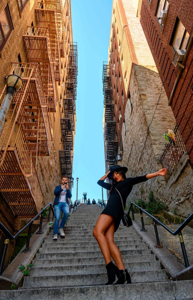 A woman does a Joker dance on the staircase in the Bronx. Photograph: Don Emmert/AFP via Getty