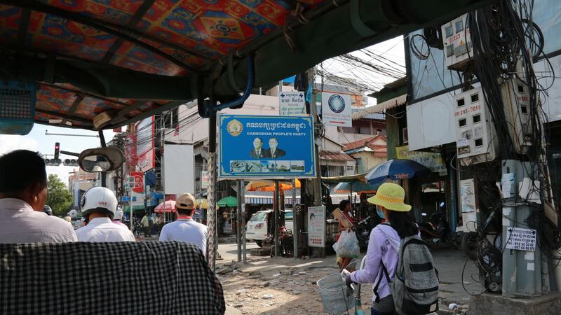 People pass a poster for the ruling Cambodia People’s Party in Phnom Penh. Photograph: Nevenka Lukin