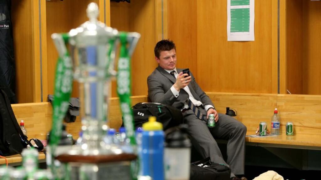 Brian O’Driscoll enjoys a quiet moment in the dressing room after the game. Photograph: Dan Sheridan/Inpho