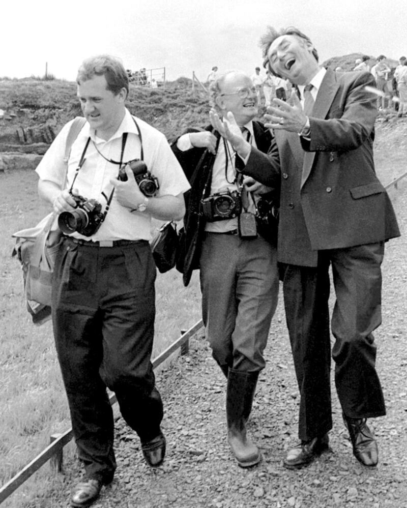 'Pádraig Flynn, like Charlie Haughey, always understood the significance of a really good picture and would happily work with a photographer, no matter what you asked him to do. He is pictured (left) at his ebullient best while he converses with photographers Colman Doyle (Irish Press) and Joe St Ledger (Irish Times) at the turning of the sod for the Céide Fields Centre, also in the early 1990s.' Photograph: Henry Wills