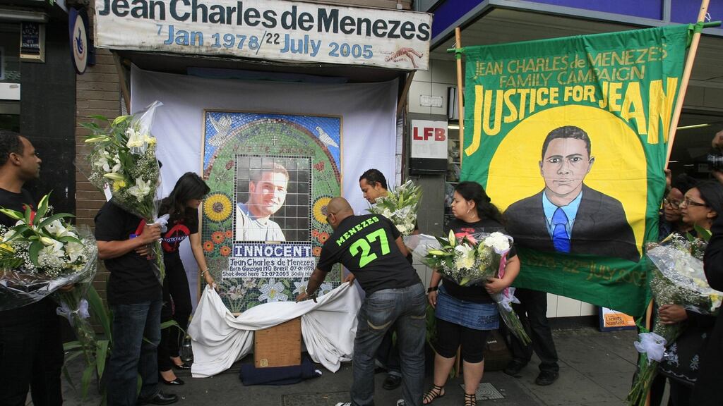 Friends and relatives of Jean Charles de Menezes marking his death outside Stockwell Tube station in London. Photograph: Johnny Green/PA Wire