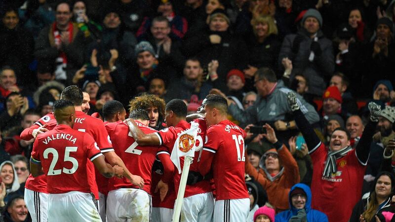 The Manchester United players celebrate their goal. Photograph: Getty Images