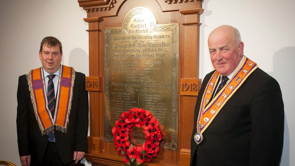 Deputy master of Loyal Orange Lodge 1063, Stewart McClean, and grand master of the Grand Orange Lodge of Ireland Edward Stevenson (right), with the restored first World War memorial tablet after it was destroyed in an arson attack in 2014 in Newtowncunningham Orange Hall. Photograph: Orange Order/PA Wire