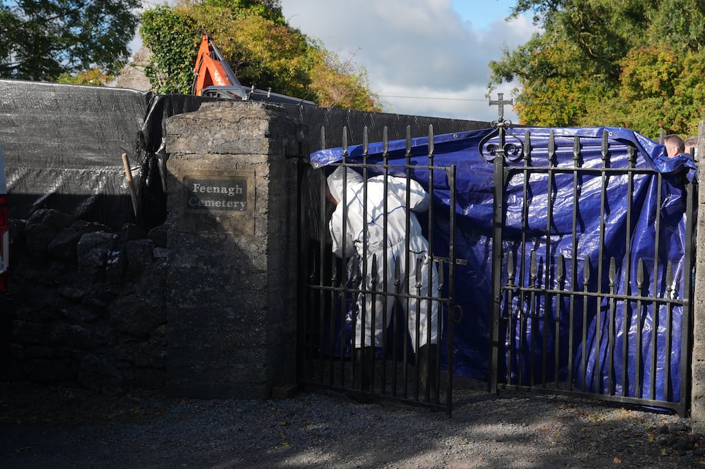 Forensic officers at the scene of the exhumation of Patrick Nugent at Feenagh Cemetery, County Clare, as part of a fresh investigation into his death at Bunratty Folk Park. Photograph: Niall Carson/PA Wire