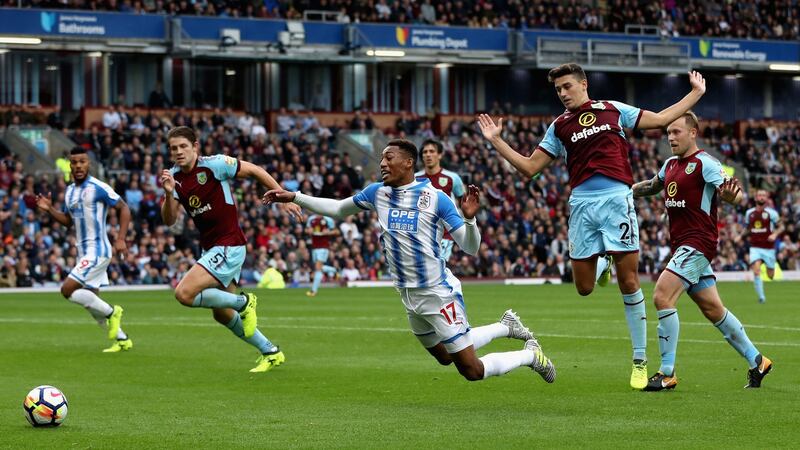 Rajiv van La Parra of Huddersfield Town is challenged in the penalty box   at Turf Moor. Photograph: Ian MacNicol/Getty Images
