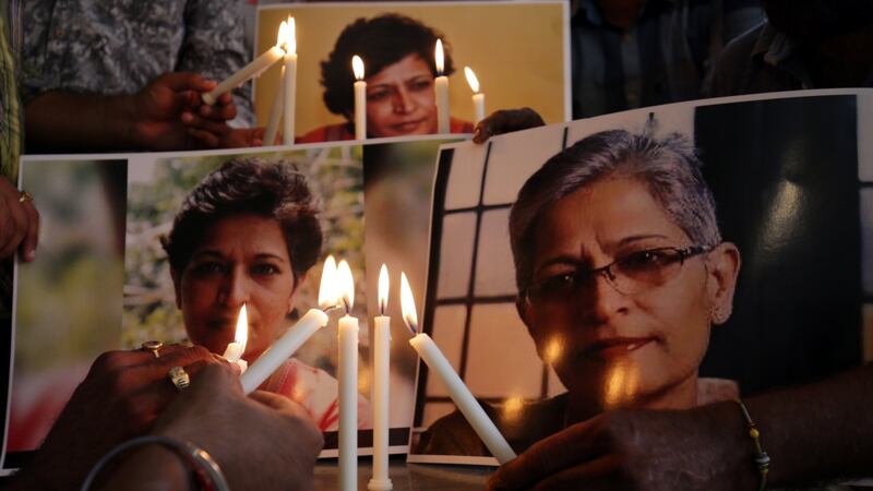 Members of the National Human Rights and Crime Control Organisation place candles near photographs of Indian journalist Gauri Lankesh during a vigil in Amritsar, India. Photograph: Raminder Pal Singh/EPA