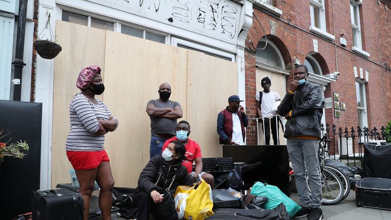 The evicted tenants among with their belongings outside the property on Berkeley Road in Dublin on Wednesday. Photograph: Nick Bradshaw