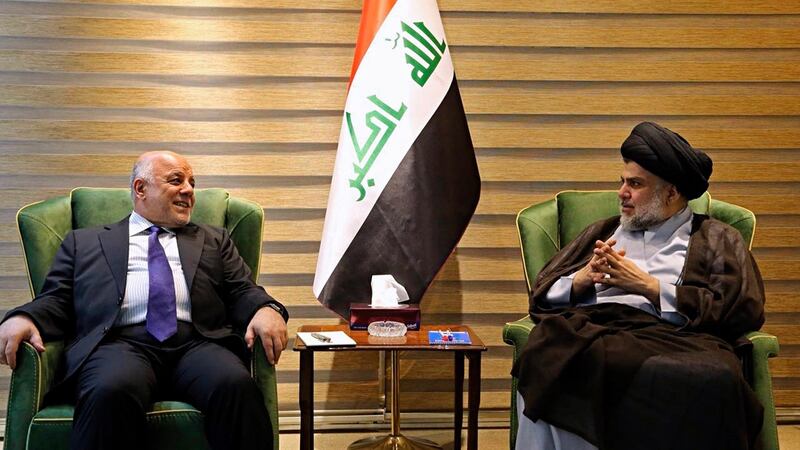 IIraqi prime minister Haider al-Abadi meeting with Muqtada al-Sadr in Baghdad on Sunday. Photograph:   Iraqi government via AP