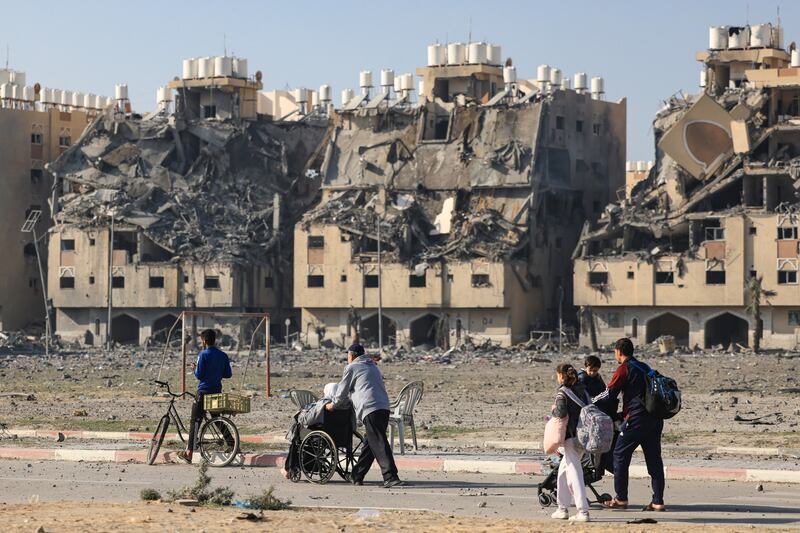 Residents of a residential complex in Khan Younis carry some of their belongings as they flee their homes after an Israeli strike on Saturday. Photograph: Mahmud Hams/AFP via Getty Images