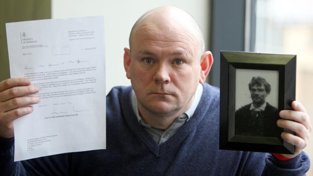 Charlie Agnew, nephew of John Pat Cunningham, with the apology from the British ministry of defence and a picture of Mr Cunningham at a press conference in Belfast yesterday. Photograph: Paul Faith/PA