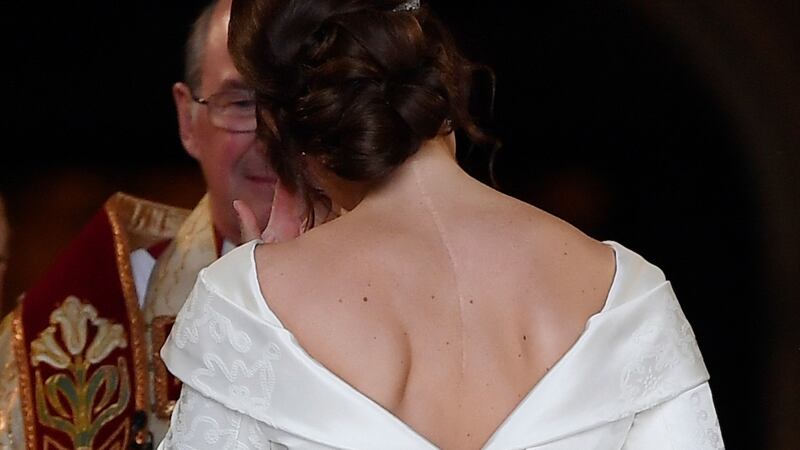 Princess Eugenie, with the scar from her surgery for scoliosis to treat a curvature of the spine at the age of 12 visible, as she enters St George’s Chapel for her wedding to. Photograph: Toby Melville/PA Wire