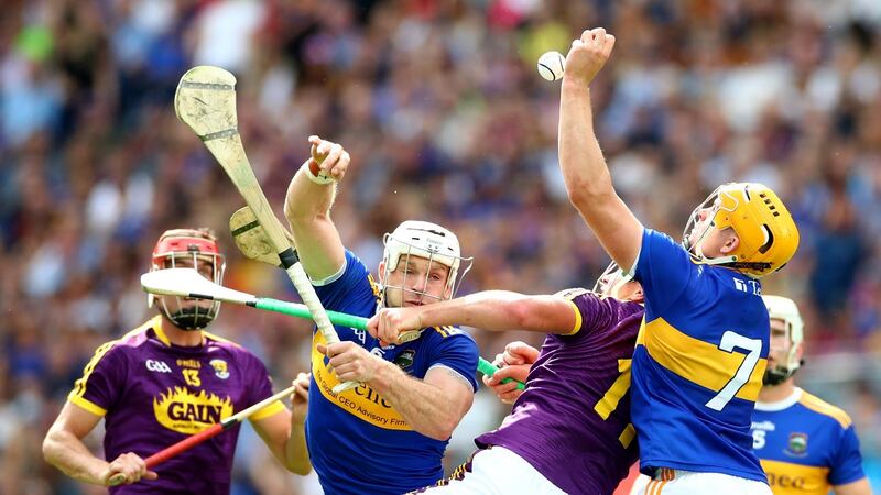 Tipperary’s Pádraic Maher and Ronan Maher battle with Wexford’s Conor McDonald. In the second half the Tipp half-back line, which also included Brendan Maher, became a wall. Photograph: James Crombie/Inpho