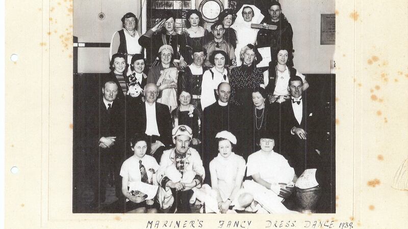 A fancy-dress party held in Dún Laoghaire parish in 1939. Canon George Chamberlain, grandfather of Julie Parsons, is seated in the front row. One guest is dressed as Adolf Hitler.