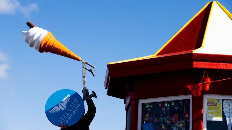 A  man prepares to open The Kiosk in Portmarnock, Co Dublin. There has been no date given for the resumption of outdoor dining, or when restaurants and bars might expect to reopen fully.   Photograph: Tom Honan