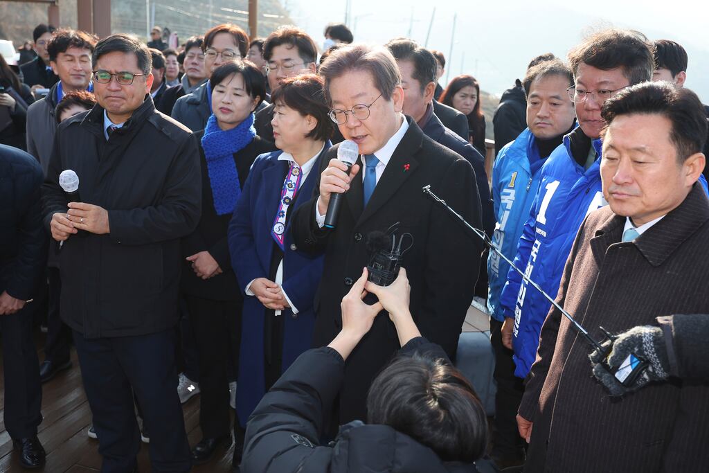 South Korean opposition leader Lee Jae-myung (centre) speaks as he visits the construction site of a new airport in Busan, South Korea. Photograph: Sohn Hyung-joo/Yonhap via AP