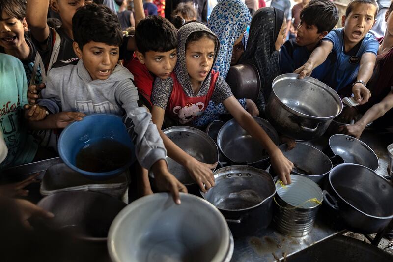Children seeing food at a grocery store that was running low on supplies in Gaza City. Photograph: Saher Alghorra/The New York Times