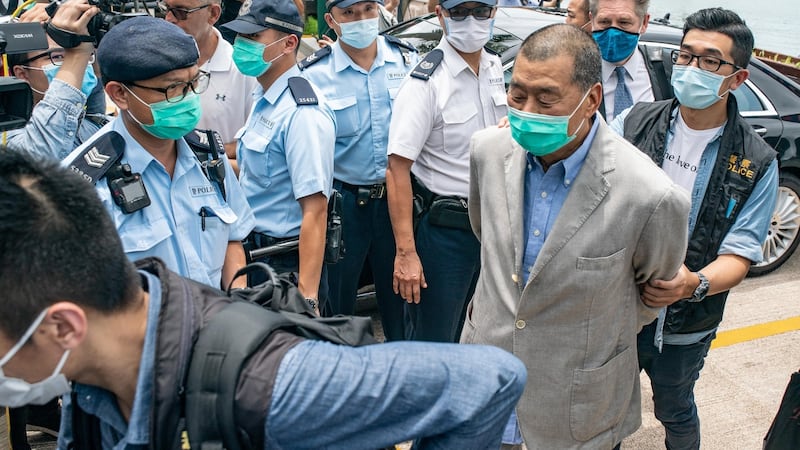 Hong Kong media tycoon and Apple Daily founder Jimmy Lai (R) is taken by the police to the Royal Hong Kong Yacht Club Shelter Cove Clubhouse for evidence collection. Photograph: Anthony Kwan/Getty Images