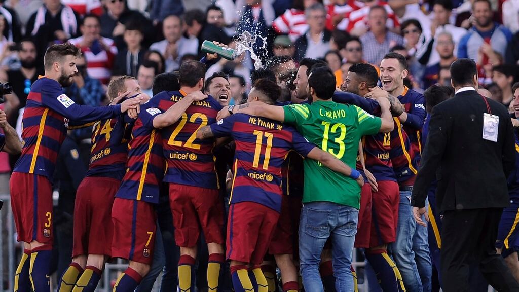 Barcelona’s players celebrate their 24th La Liga title at Nuevo Los Carmenes stadium in Granada. Photograph: Getty Images