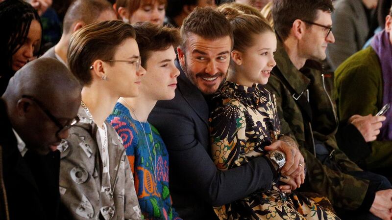 David Beckham, with his children Romeo, Cruz and Harper, at the Victoria Beckham catwalk show during London Fashion Week on Sunday. Photograph: Henry Nicholls/Reuters