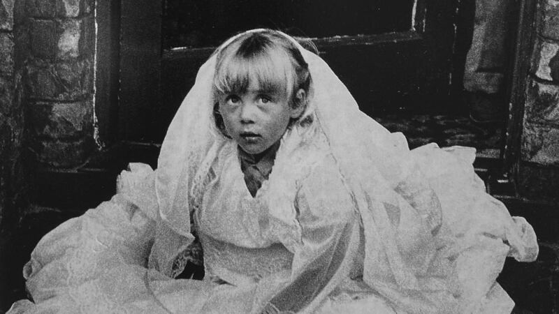 A child in first communion dress inBelfast 1987. Photograph: Markéta LuskaÄ?ová