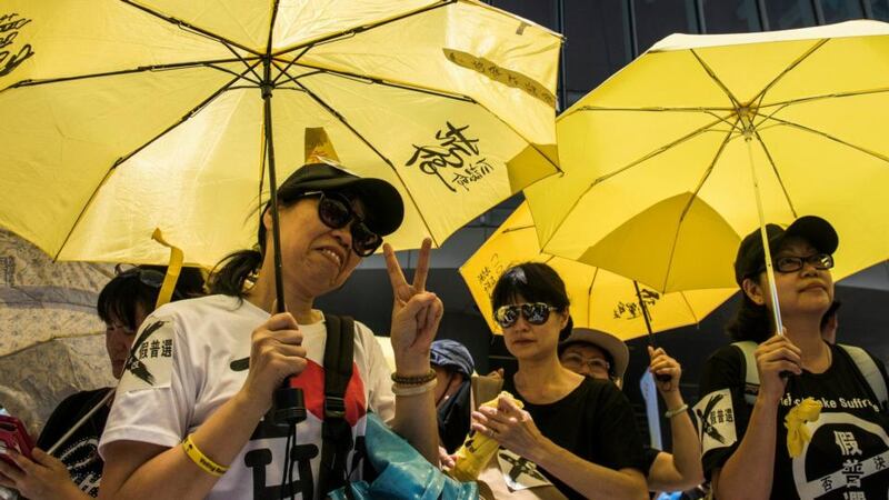 Pro-democracy protesters holding yellow umbrellas outside the Hong Kong Legislative Council after politicians voted down a China-backed election plan. Photograph: Xaume Olleros/Bloomberg.