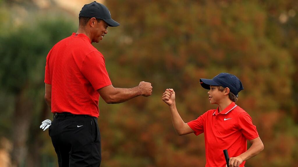 Tiger Woods fist bumps his son Charlie on the 18th hole during the final round of the PNC Championship at the Ritz-Carlton Golf Club in Orlando in December 2020. Photograph: Mike Ehrmann/Getty Images