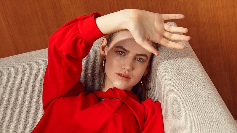 Tie neck red dress by Tara Jarmon €210, earrings €89 Calvin Klein, West Elm Andes corner sofa €2699