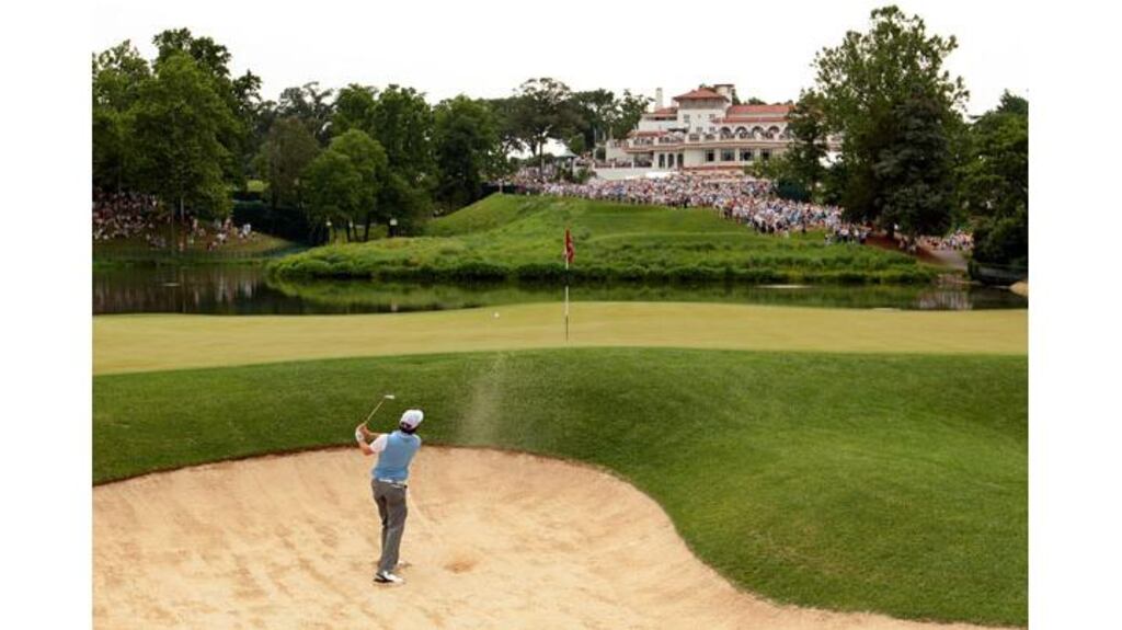 Rory McIlroy plays a bunker shot at the 10th hole as he stretched his lead at the US Open. Photograph: Ross Kinnaird/Getty Images